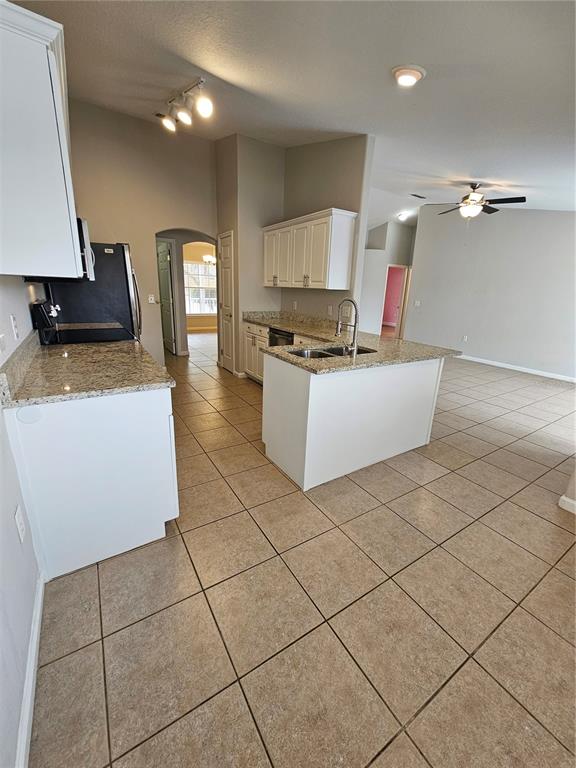 4182 Bedford Road Sanford, FL 32773 - Photo 8 of 18 a kitchen with granite countertop a sink a stove top oven and cabinets