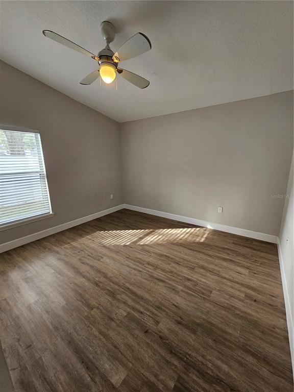 4182 Bedford Road Sanford, FL 32773 - Photo 9 of 18 a view of empty room with wooden floor and window
