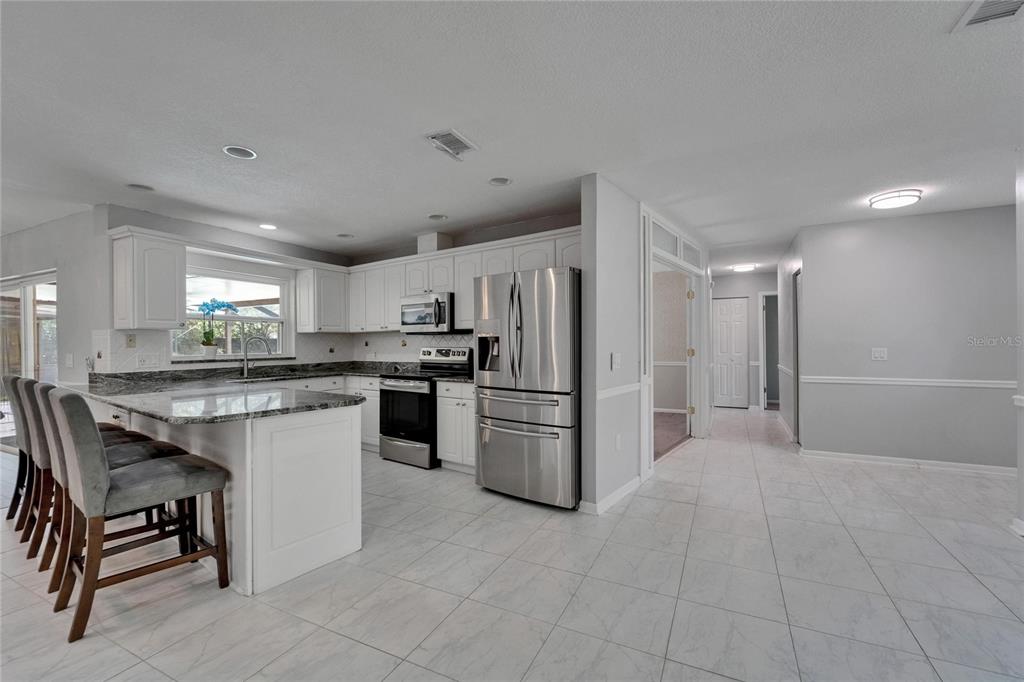 9403 Bellhaven Street Temple Terrace, FL 33637 - Photo 11 of 59 a kitchen with a refrigerator and a sink