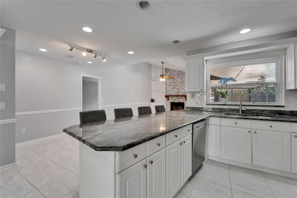 9403 Bellhaven Street Temple Terrace, FL 33637 - Photo 16 of 59 a kitchen with center island table and chairs