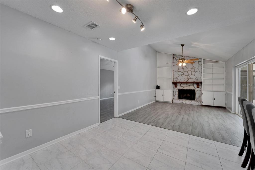 9403 Bellhaven Street Temple Terrace, FL 33637 - Photo 19 of 59 an empty room with windows and fireplace