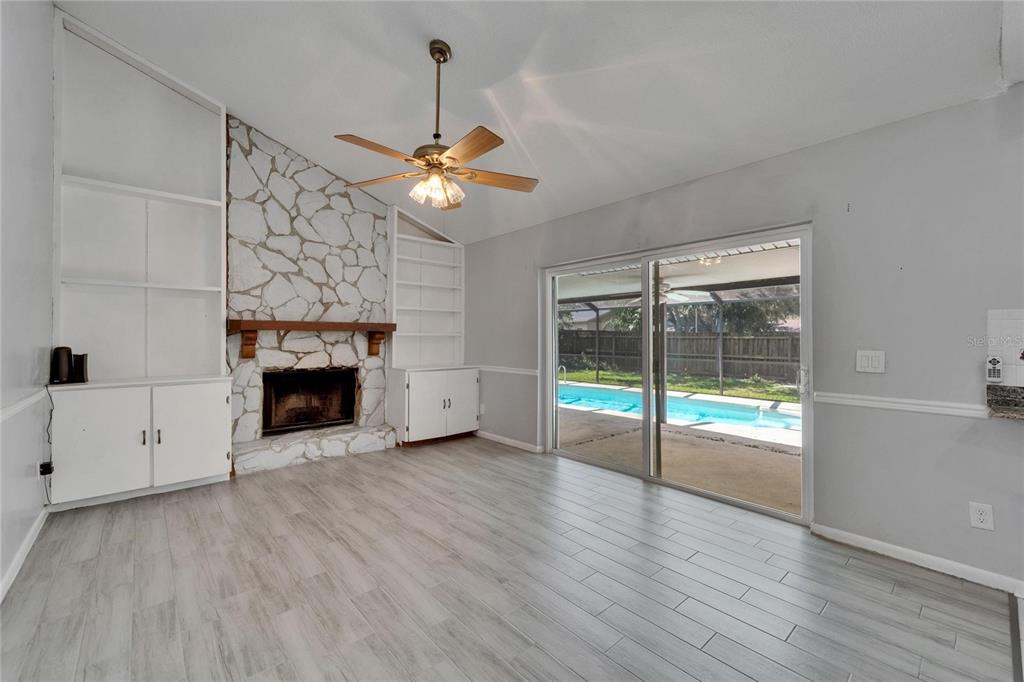 9403 Bellhaven Street Temple Terrace, FL 33637 - Photo 21 of 59 a view of an empty room with a fireplace and a window