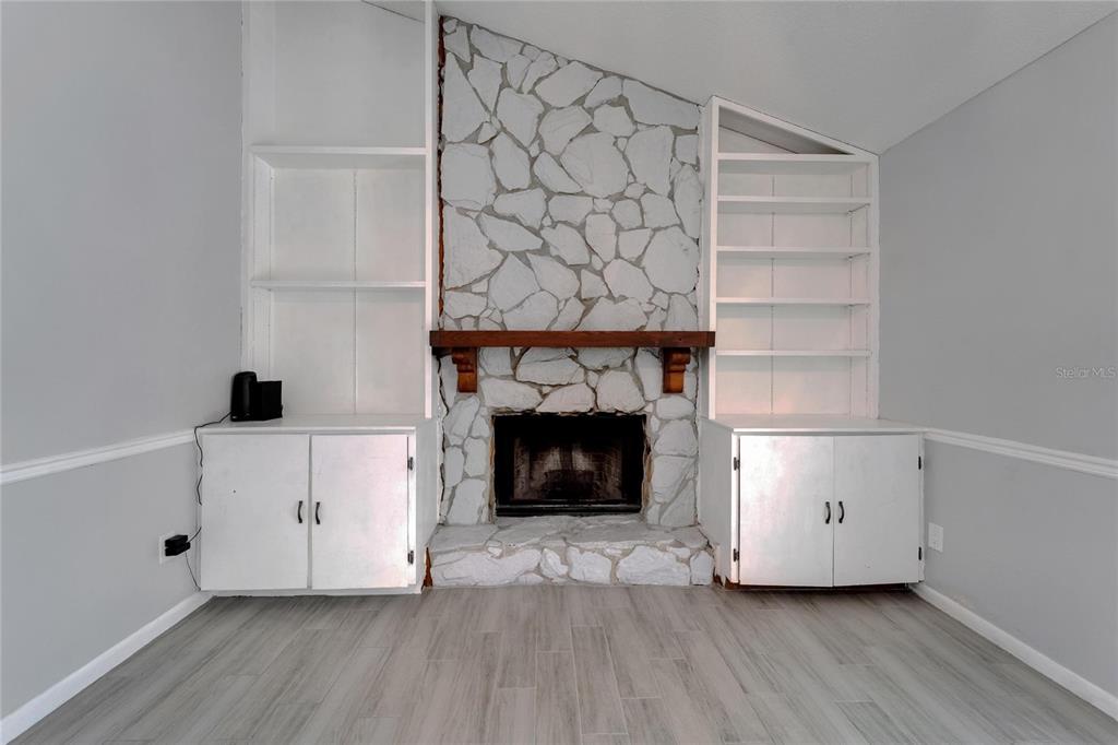 9403 Bellhaven Street Temple Terrace, FL 33637 - Photo 22 of 59 a view of a livingroom with wooden floor and a fireplace