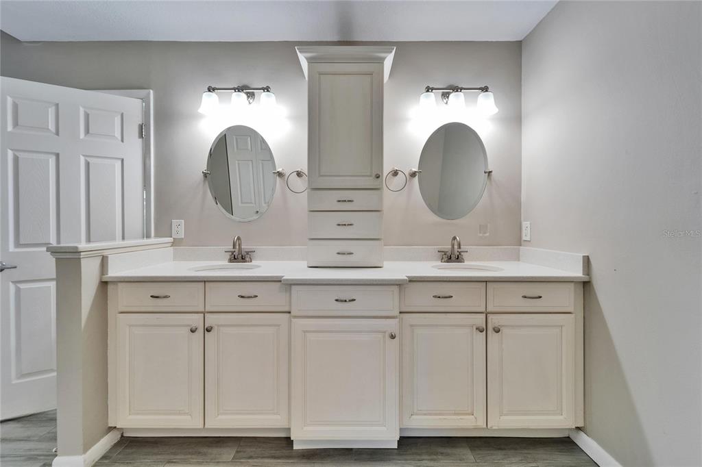 9403 Bellhaven Street Temple Terrace, FL 33637 - Photo 27 of 59 a bathroom with double vanity white and mirrors