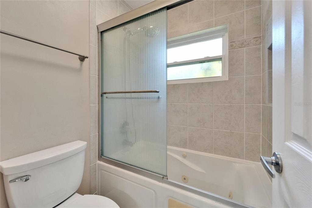 9403 Bellhaven Street Temple Terrace, FL 33637 - Photo 28 of 59 a bathroom with a shower and a toilet