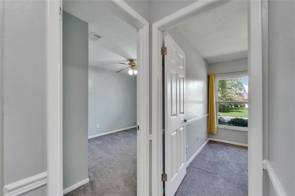 9403 Bellhaven Street Temple Terrace, FL 33637 - Photo 32 of 59 a view of a hallway with wooden shelves