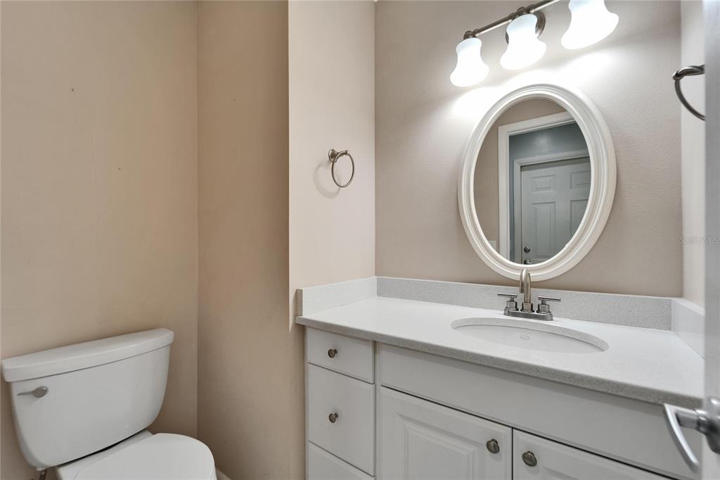 9403 Bellhaven Street Temple Terrace, FL 33637 - Photo 39 of 59 a bathroom with a toilet sink and mirror