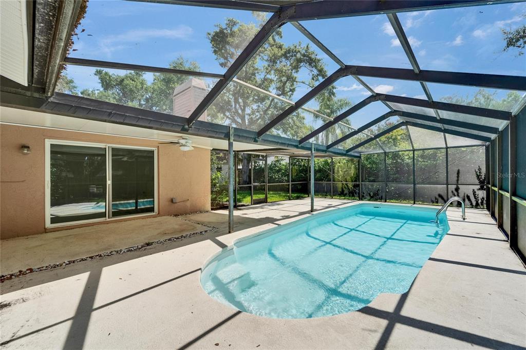 9403 Bellhaven Street Temple Terrace, FL 33637 - Photo 42 of 59 a house view with a sitting space and glass windows