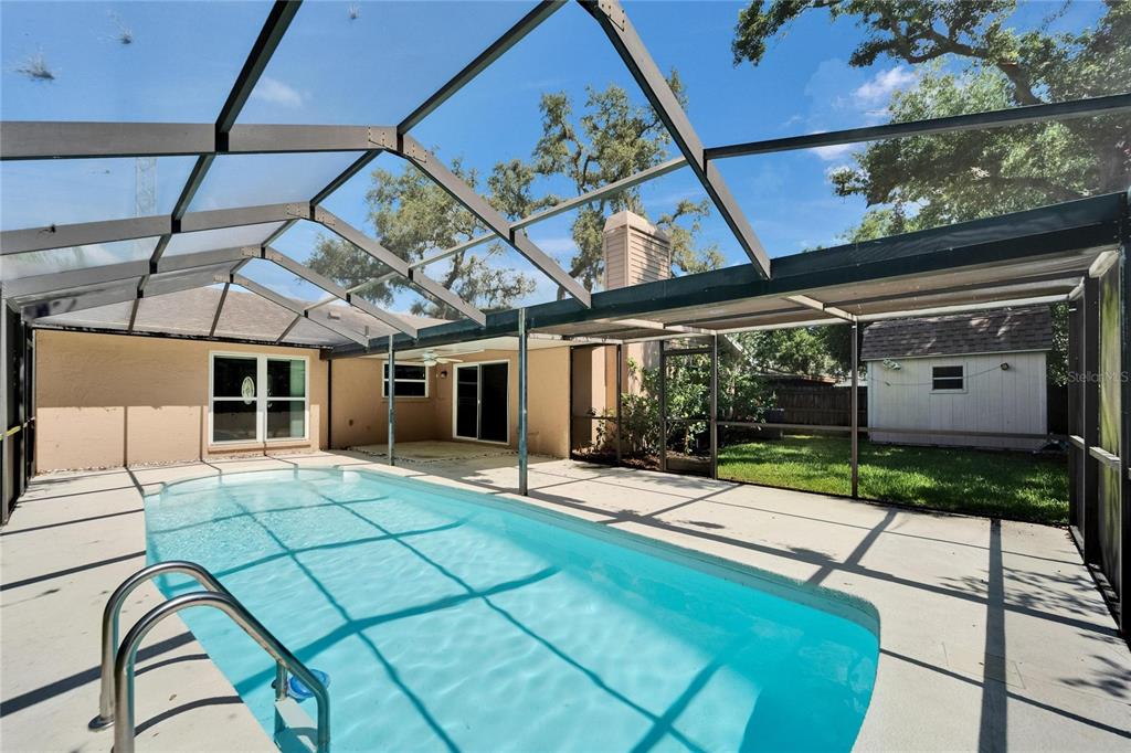 9403 Bellhaven Street Temple Terrace, FL 33637 - Photo 44 of 59 a view of a porch with a table and chairs