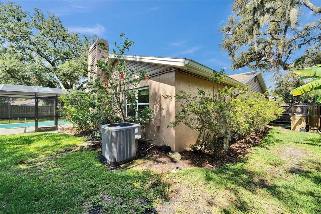 9403 Bellhaven Street Temple Terrace, FL 33637 - Photo 45 of 59 a view of a house with a yard and potted plants