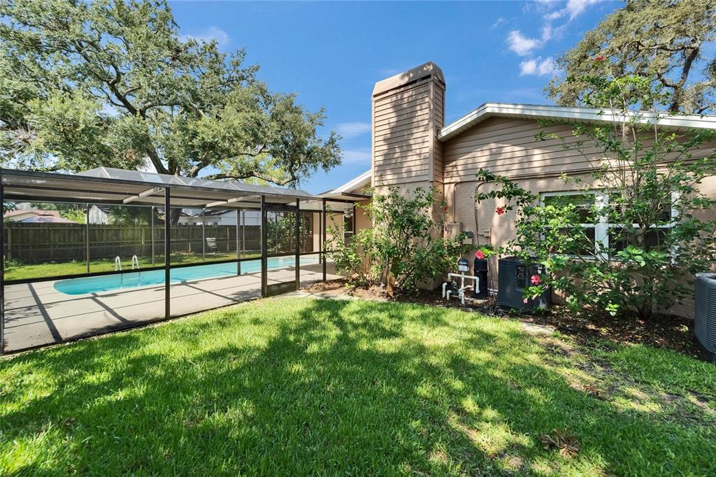 9403 Bellhaven Street Temple Terrace, FL 33637 - Photo 48 of 59 a view of a house with a yard and sitting area