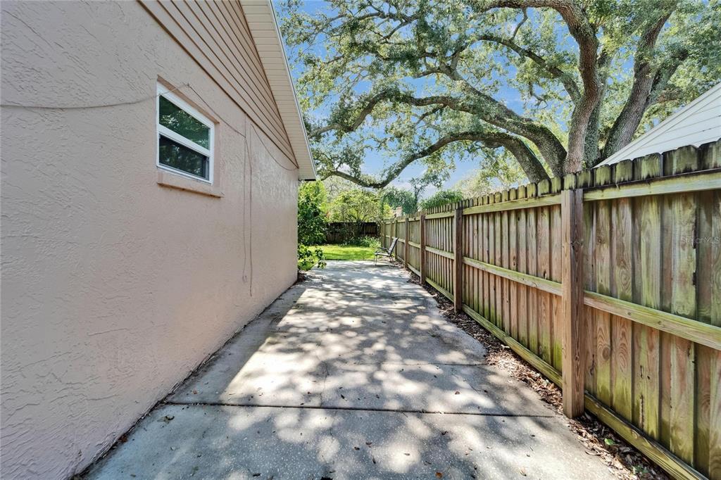 9403 Bellhaven Street Temple Terrace, FL 33637 - Photo 52 of 59 a view of a pathway of a house with a small yard