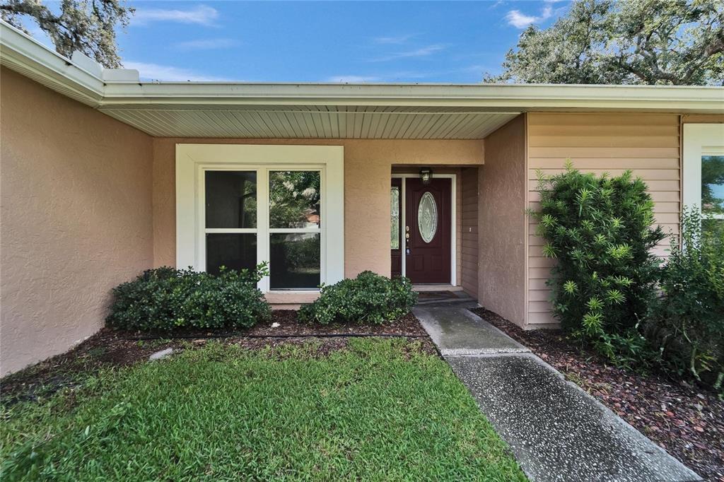 9403 Bellhaven Street Temple Terrace, FL 33637 - Photo 6 of 59 a front view of a house with garden