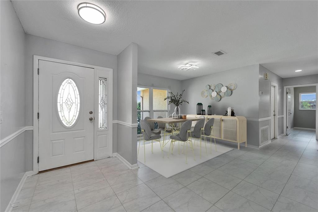 9403 Bellhaven Street Temple Terrace, FL 33637 - Photo 8 of 59 a living room with furniture a large window and entryway