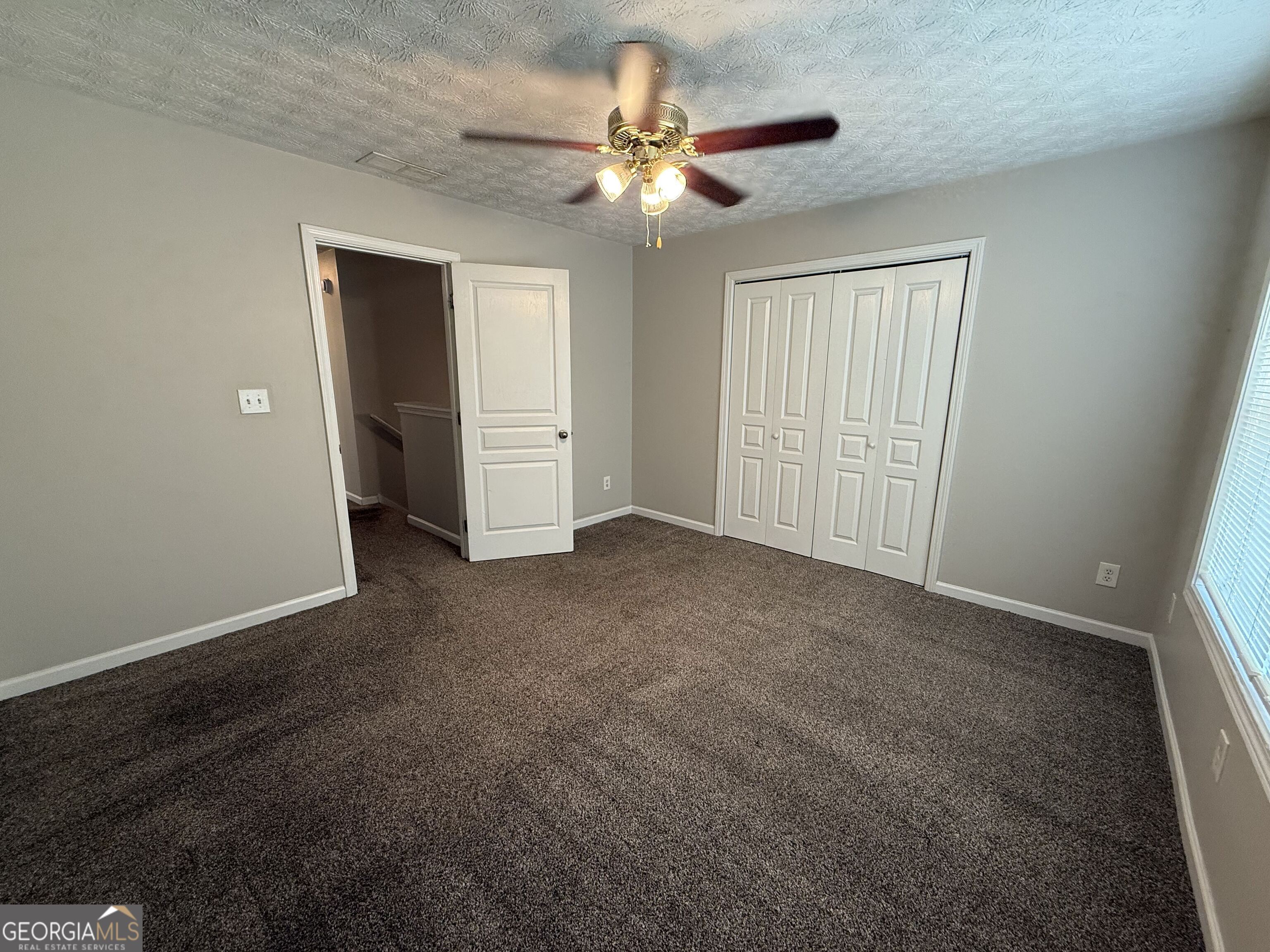 6132 Ruth Street Southwest Covington, GA 30014 - Photo 24 of 33 a view of an empty room with a ceiling fan