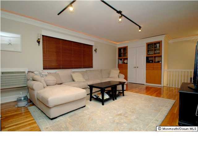 283 Spring Street, Unit 7C Red Bank, NJ 07701 - Photo 2 of 3 a living room with furniture and a flat screen tv