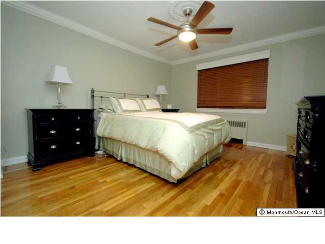 283 Spring Street, Unit 7C Red Bank, NJ 07701 - Photo 3 of 3 a bedroom with a bed and a tv