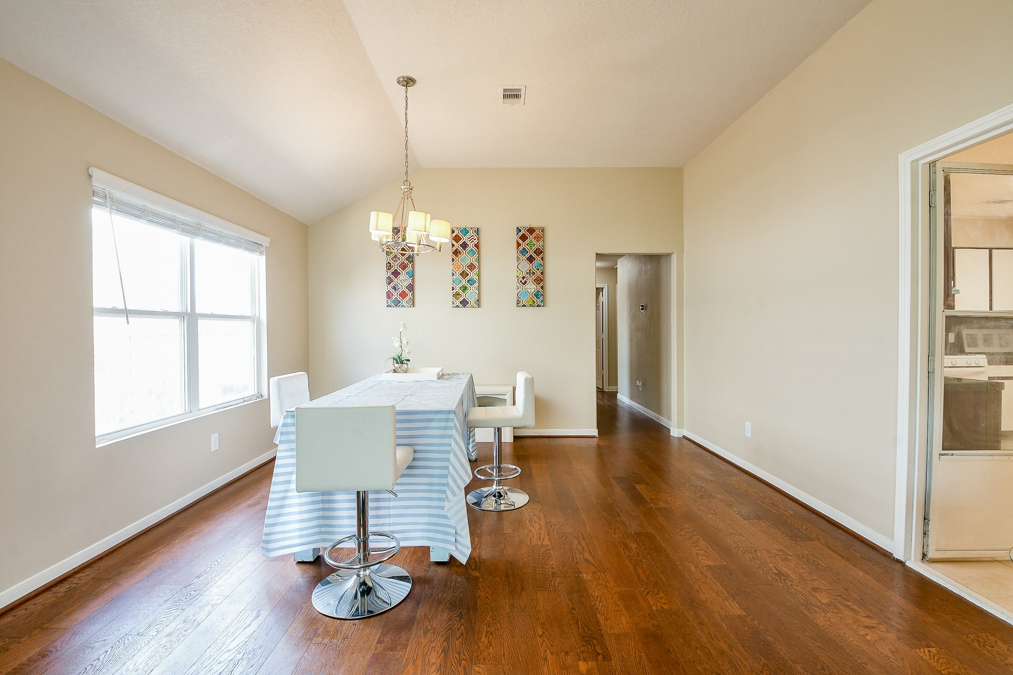5818 Turmeric Drive Baytown, TX 77521 - Photo 12 of 50 a view of a dining room with furniture a chandelier and wooden floor