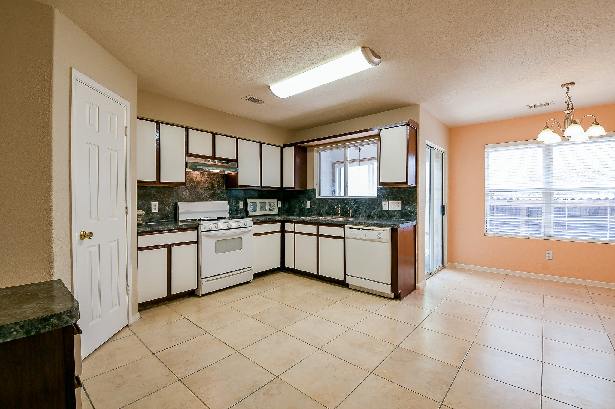 5818 Turmeric Drive Baytown, TX 77521 - Photo 17 of 50 a kitchen with stainless steel appliances granite countertop a stove a sink dishwasher a refrigerator and white cabinets with wooden floor