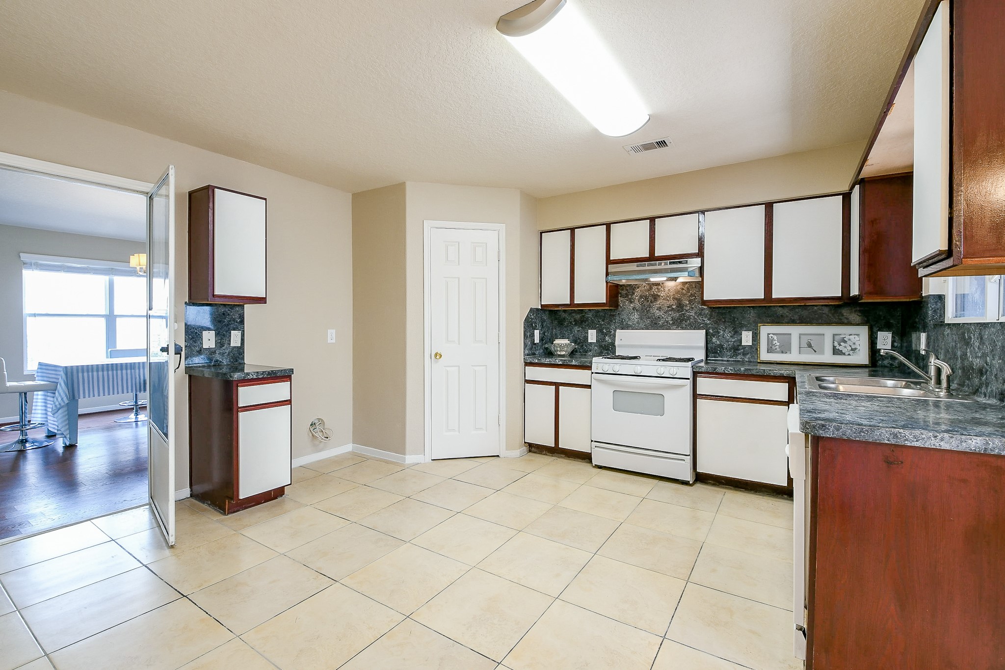 5818 Turmeric Drive Baytown, TX 77521 - Photo 21 of 50 a kitchen with stainless steel appliances granite countertop a stove a sink and a refrigerator