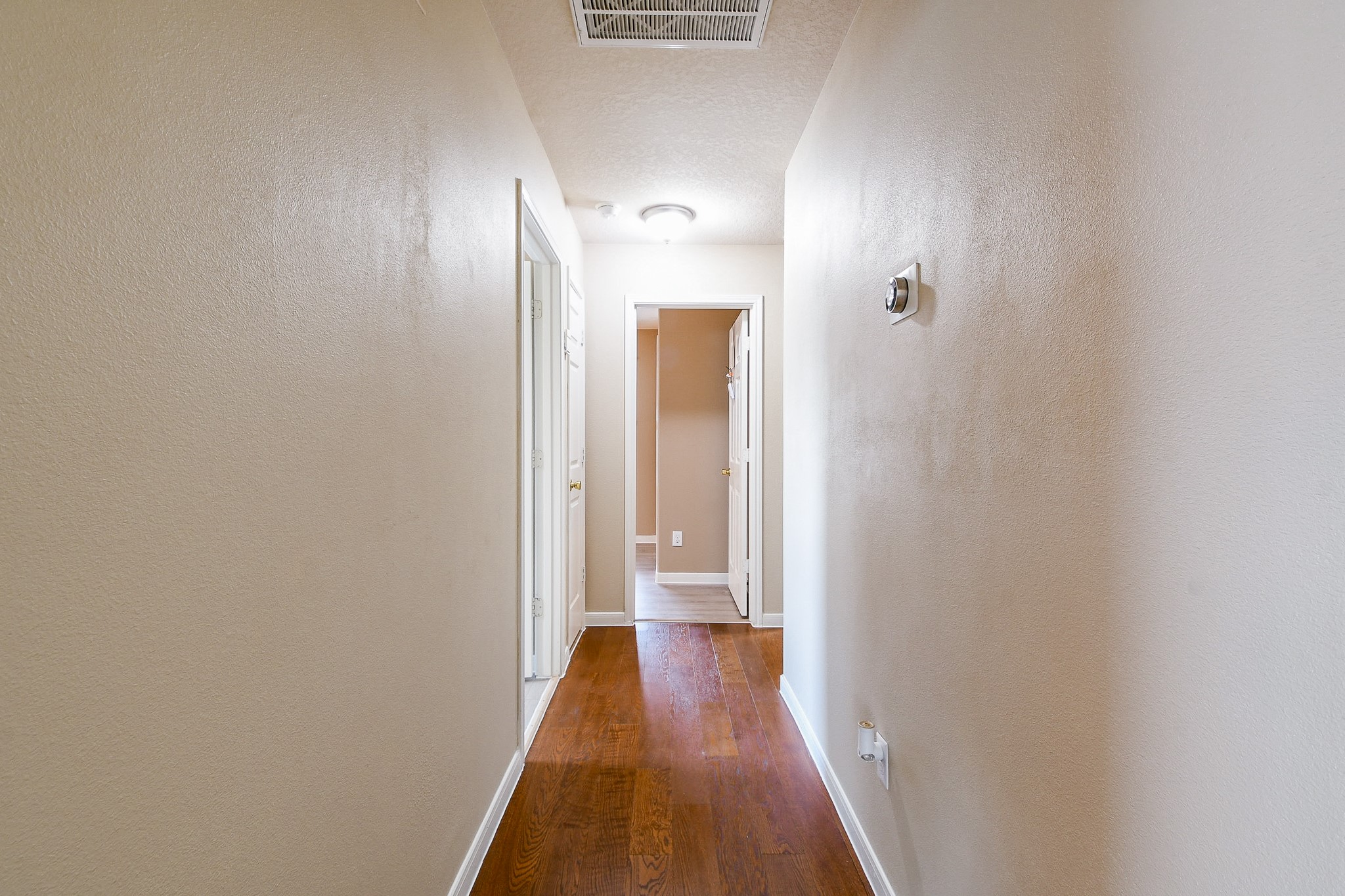 5818 Turmeric Drive Baytown, TX 77521 - Photo 30 of 50 a view of a hallway with wooden floor