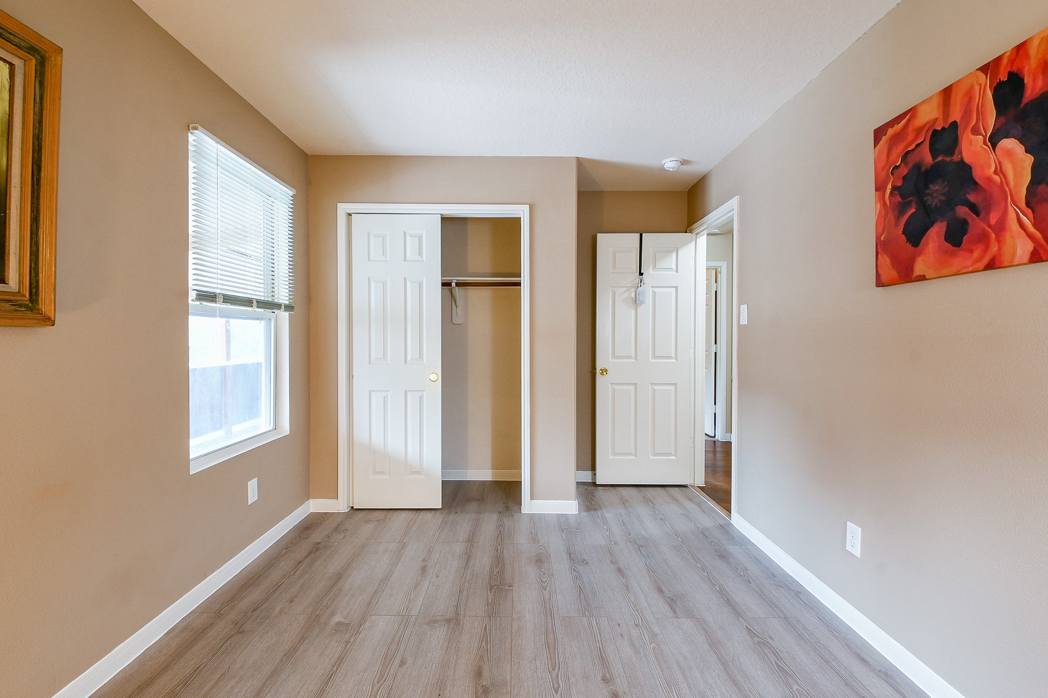 5818 Turmeric Drive Baytown, TX 77521 - Photo 38 of 50 an empty room with wooden floor and windows