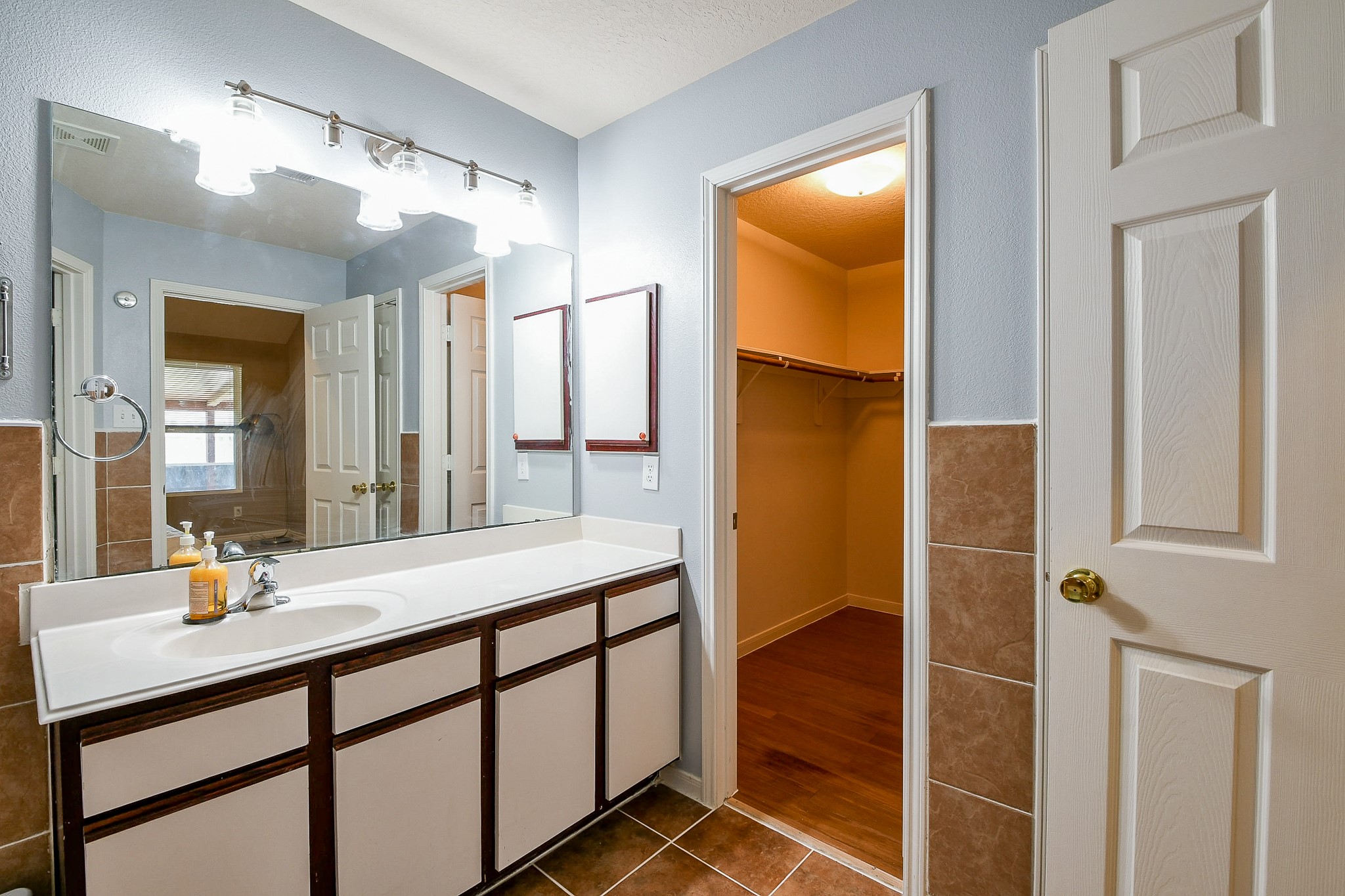 5818 Turmeric Drive Baytown, TX 77521 - Photo 44 of 50 a bathroom with a double vanity sink and a mirror