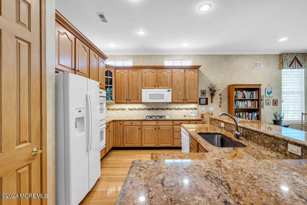 27 Exeter Drive Freehold, NJ 07728 - Photo 13 of 55 a kitchen with stainless steel appliances granite countertop a refrigerator sink and cabinets