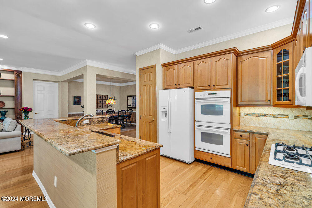 27 Exeter Drive Freehold, NJ 07728 - Photo 15 of 55 a kitchen with stainless steel appliances granite countertop a refrigerator and a stove top oven