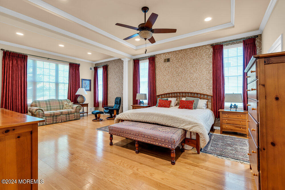 27 Exeter Drive Freehold, NJ 07728 - Photo 21 of 55 a spacious bedroom with a bed a couch and a large window