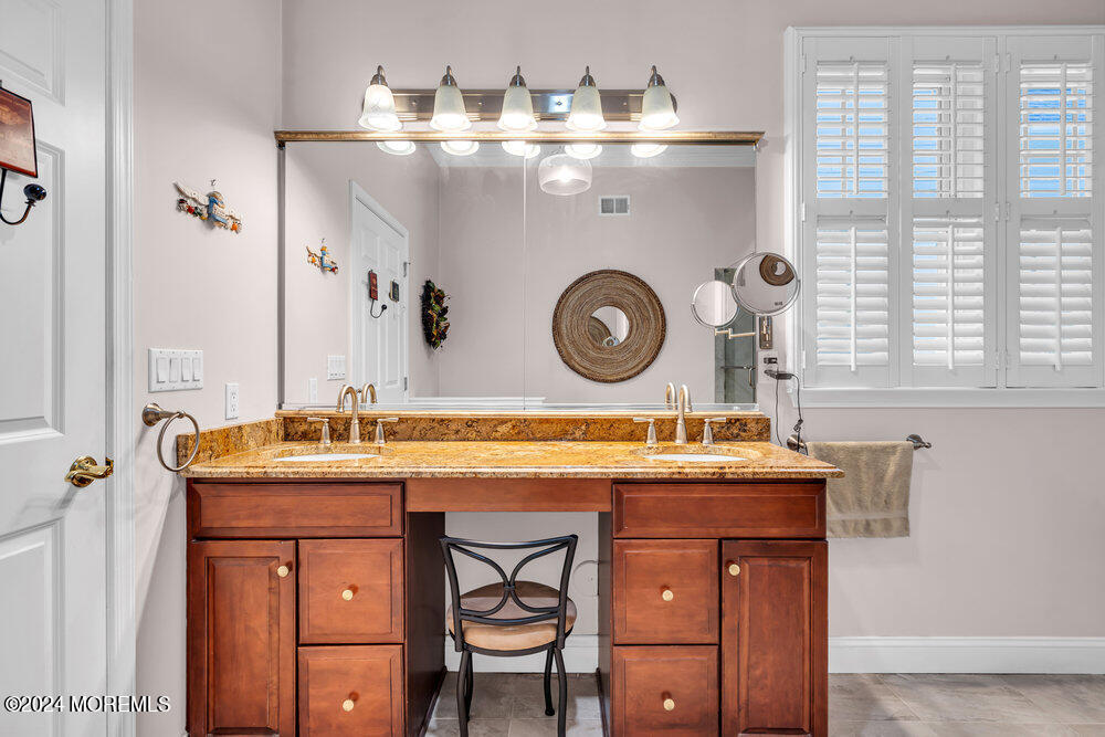 27 Exeter Drive Freehold, NJ 07728 - Photo 27 of 55 a utility room with a stove a washer and dryer