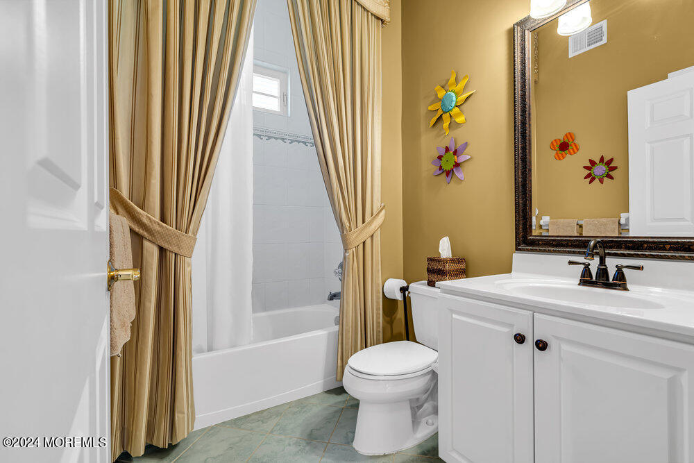 27 Exeter Drive Freehold, NJ 07728 - Photo 32 of 55 a bathroom with a sink a toilet and shower curtain