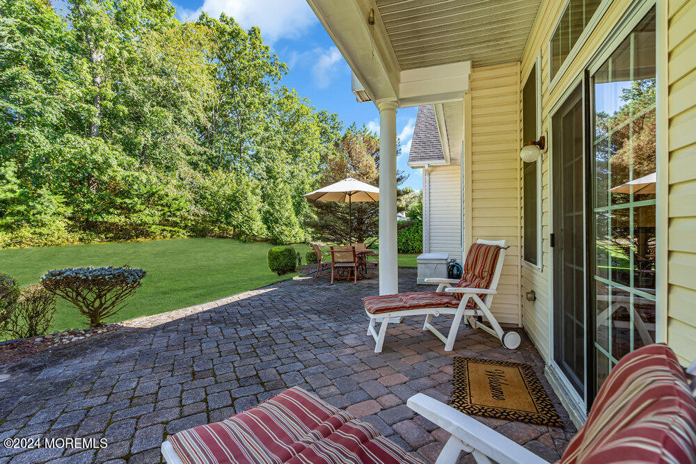 27 Exeter Drive Freehold, NJ 07728 - Photo 39 of 55 a view of a patio with a table chairs and a yard
