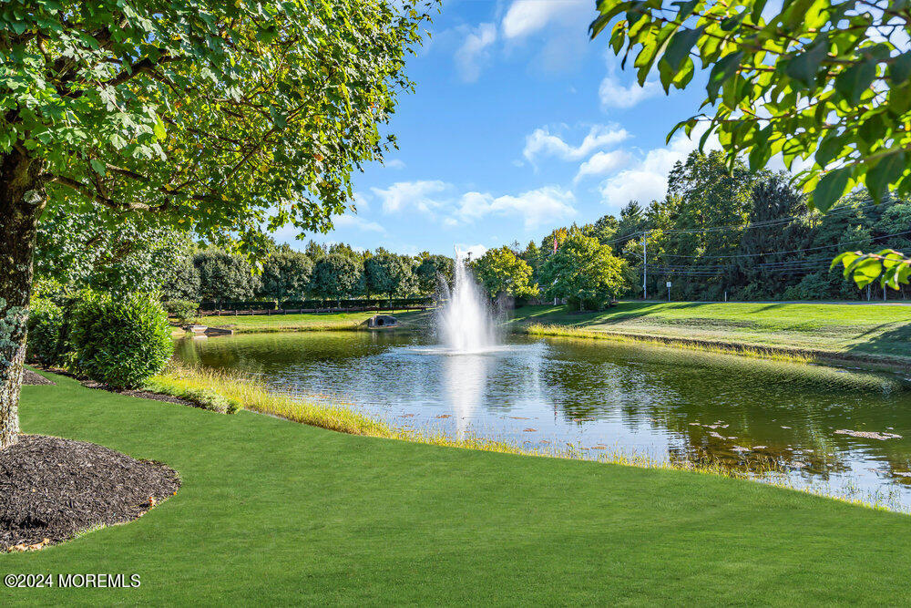27 Exeter Drive Freehold, NJ 07728 - Photo 43 of 55 a view of a lake with a yard in back