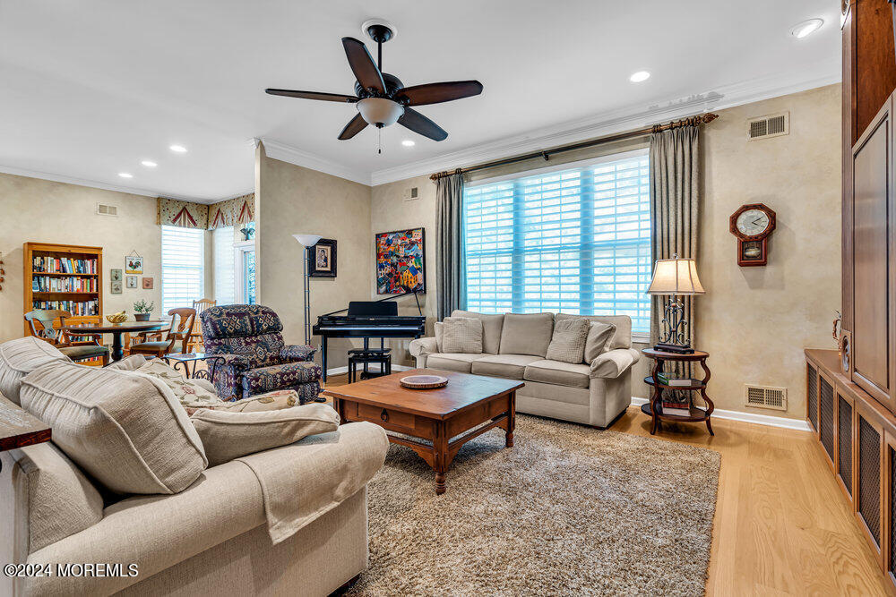 27 Exeter Drive Freehold, NJ 07728 - Photo 8 of 55 a living room with furniture ceiling fan and a window