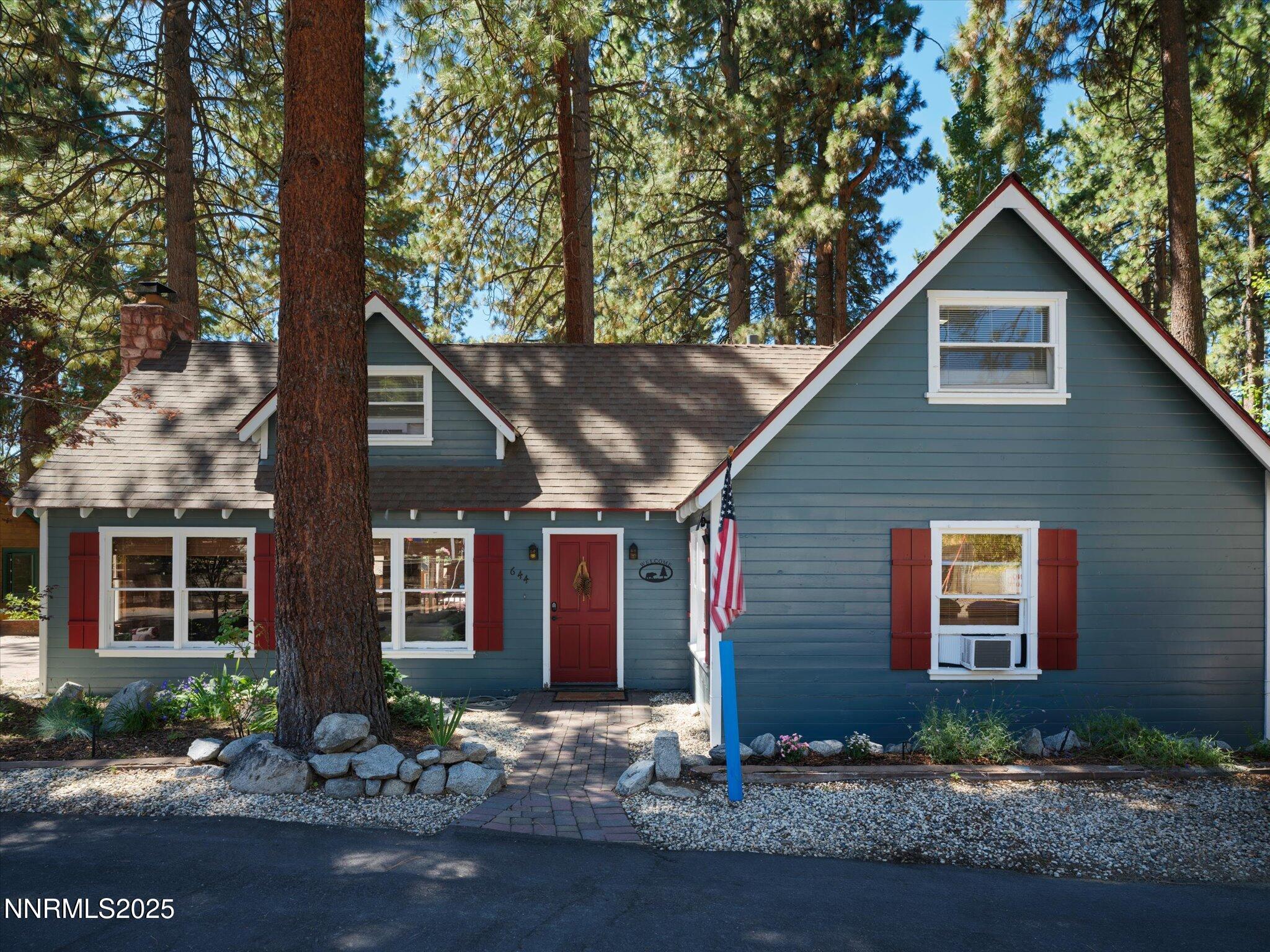 644 Job Lane Zephyr Cove, NV 89448 - Photo 1 of 26 a front view of a house with yard and green space