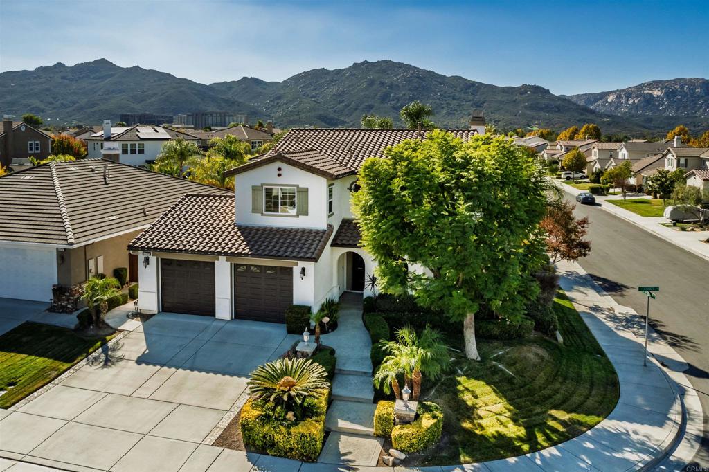 a view of a house with a garden and a mountain view