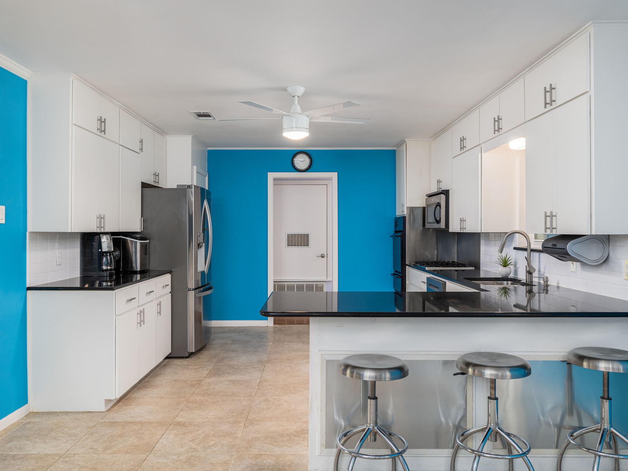 4710 Frontier Trail Austin, TX 78745 - Photo 10 of 32 a kitchen with stainless steel appliances a sink a stove a refrigerator cabinets and chairs
