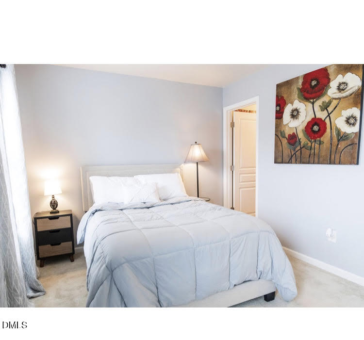 3904 Swinton Street Raleigh, NC 27616 - Photo 11 of 20 a bedroom with a bed and a painting on the wall