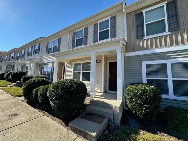 a view of a brick building next to a yard