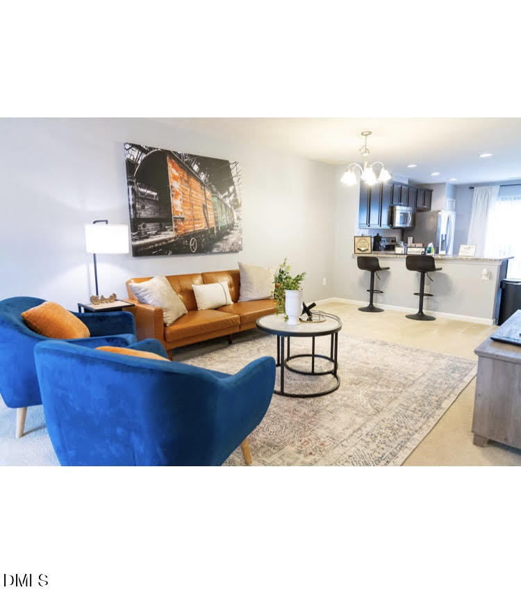 3904 Swinton Street Raleigh, NC 27616 - Photo 3 of 20 a living room with furniture and a flat screen tv