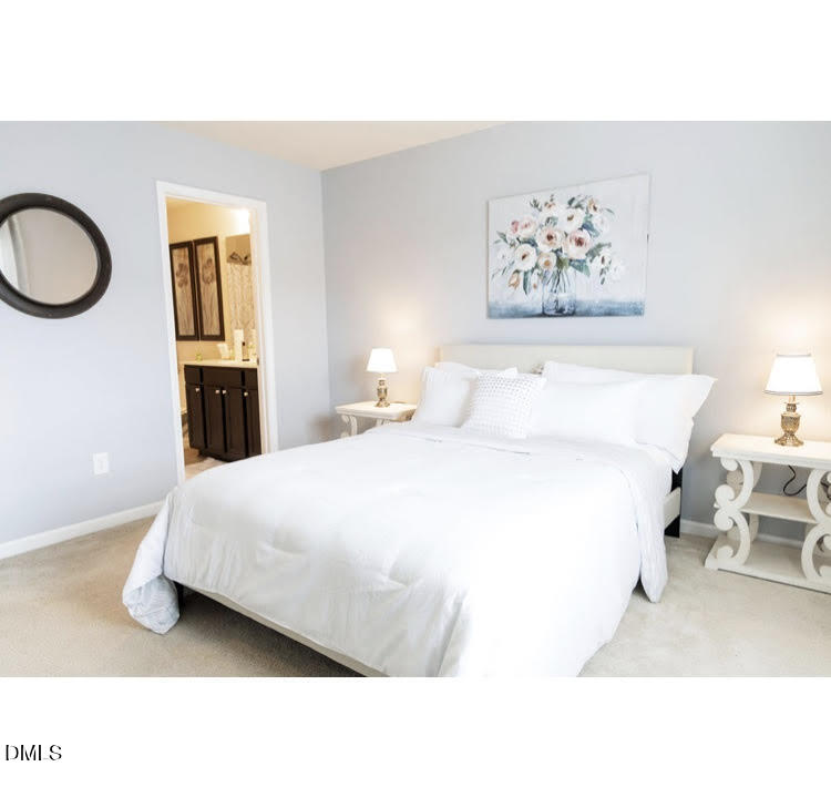 3904 Swinton Street Raleigh, NC 27616 - Photo 9 of 20 a bedroom with a bed and a chandelier