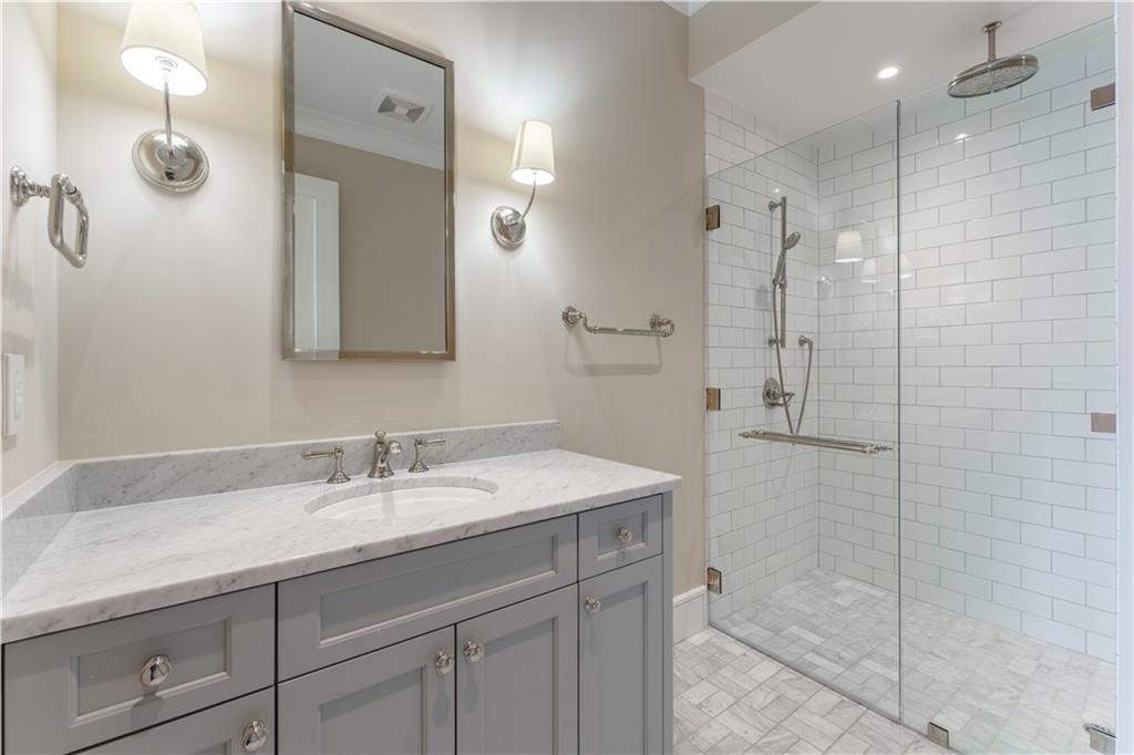 3376 Peachtree Road Northeast, Unit 35A Atlanta, GA 30326 - Photo 14 of 23 a bathroom with a sink shower and a mirror