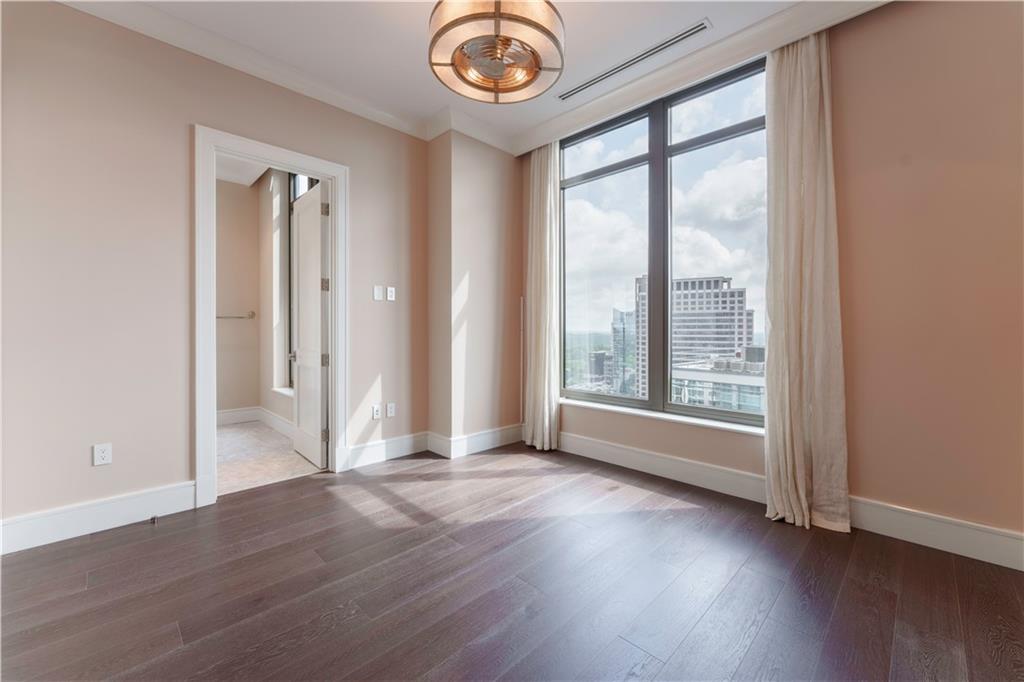 3376 Peachtree Road Northeast, Unit 35A Atlanta, GA 30326 - Photo 15 of 23 an empty room with wooden floor and windows