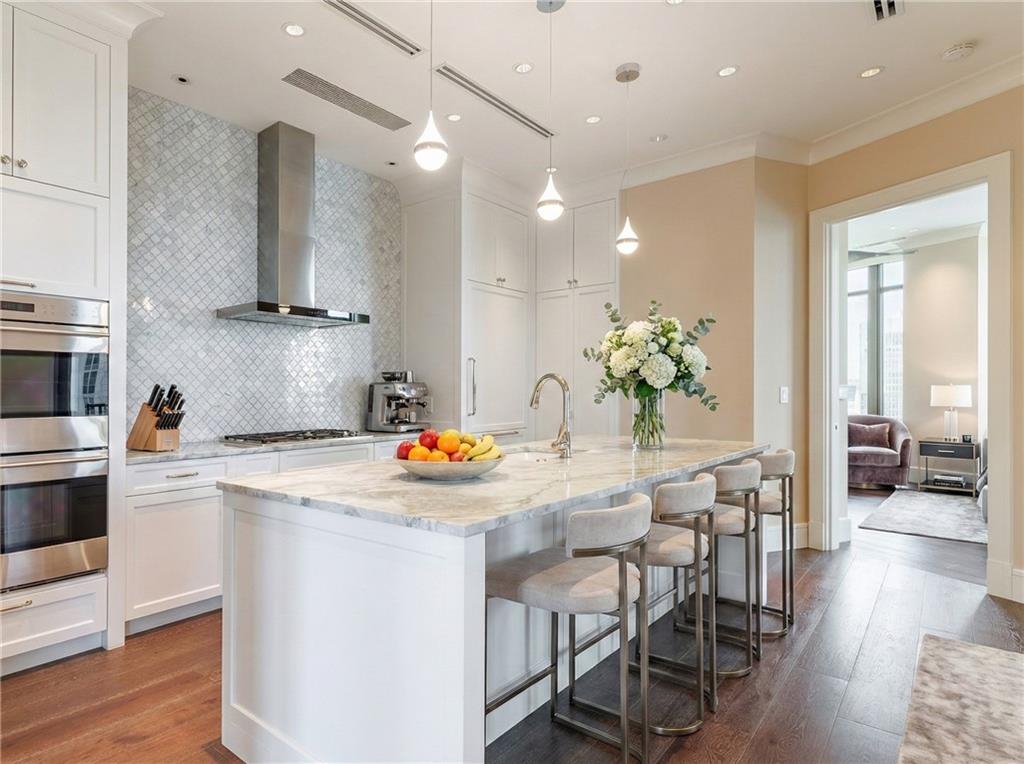 3376 Peachtree Road Northeast, Unit 35A Atlanta, GA 30326 - Photo 4 of 23 a kitchen with stainless steel appliances kitchen island a table and chairs in it