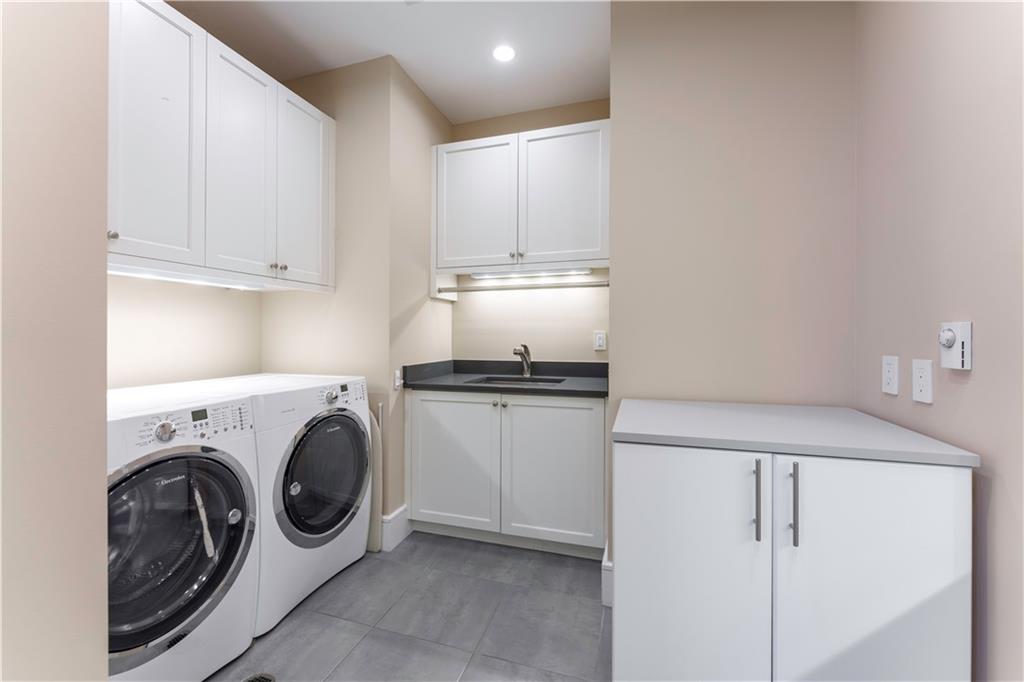 3376 Peachtree Road Northeast, Unit 35A Atlanta, GA 30326 - Photo 8 of 23 a kitchen with cabinets washer and dryer
