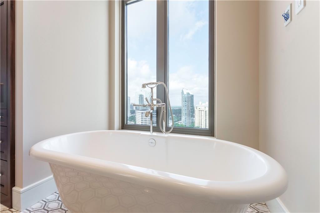 3376 Peachtree Road Northeast, Unit 35A Atlanta, GA 30326 - Photo 9 of 23 a white bath tub sitting in a bathroom next to a window