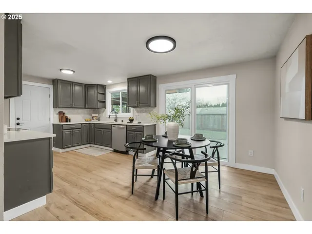 a view of a dining room with furniture and a window