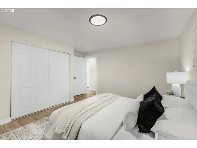 a bedroom with a bed and a night stand