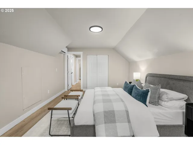 a bedroom with a bed and a desk